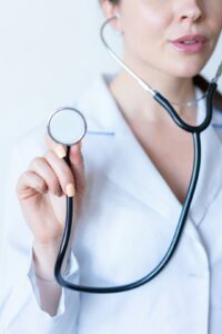 A patient discussing health concerns with a healthcare provider in a clean, well-lit exam room.