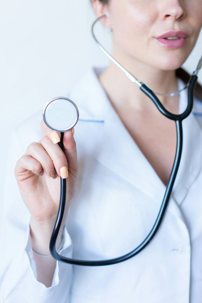 A patient discussing health concerns with a healthcare provider in a clean, well-lit exam room.